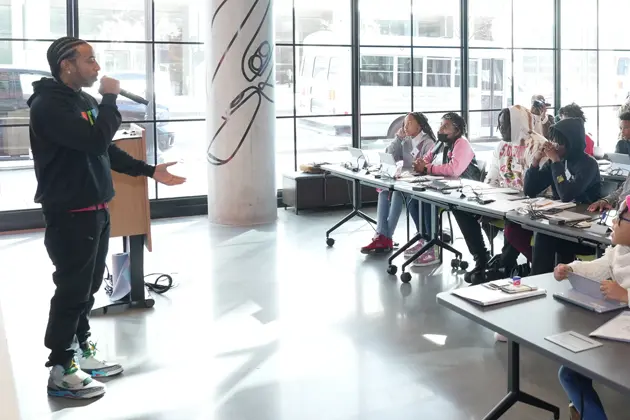 An image of Chris 'Ludacris' Bridges wearing a Ludacris Foundation t-shirt. He is gesturing with his hand as he speaks.